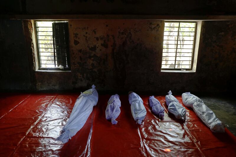 Bodies of Rohingya refugees, who died when their boat capsized while fleeing Myanmar, are placed in a local madrasa where victims' bodies were brought to, in Shah Porir Dwip, in Teknaf, near Cox's Bazar in Bangladesh. Damir Sagolj / Reuters