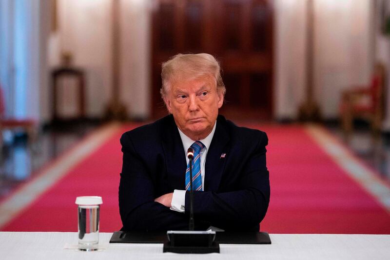 US President Donald Trump sits with his arms crossed during a roundtable discussion on the Safe Reopening of America’s Schools amid the coronavirus pandemic, in the East Room of the White House, in Washington DC. AFP