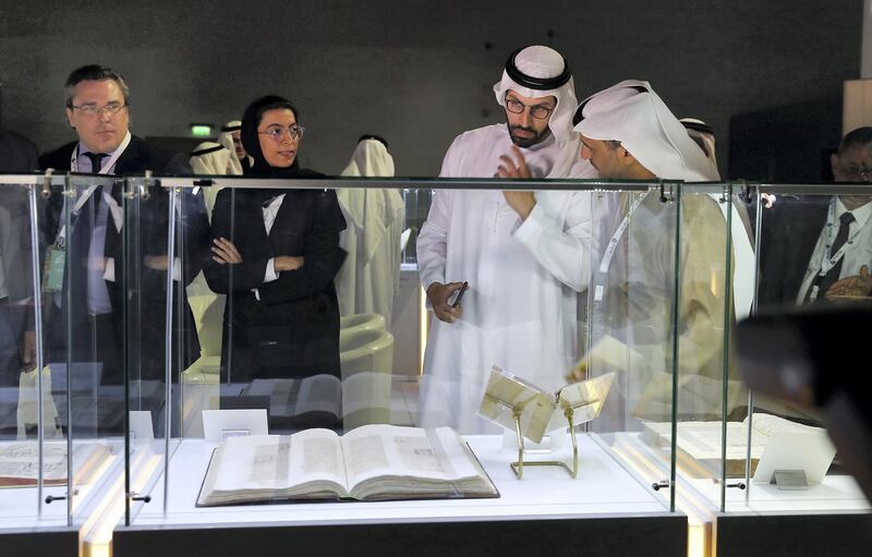 ABU DHABI , UNITED ARAB EMIRATES , January 16 ��� 2019 :- Mohamed Khalifa Al Mubarak , Chairman of Abu Dhabi Tourism & Culture Authority ( 2nd from right ) and Noura bint Mohammed Al Kaabi , Minister of Culture and Knowledge Development for the United Arab Emirates ( 2nd from Left ) looking at the manuscripts during the Manuscripts Conference held at Manarat Al Saadiyat in Abu Dhabi. (Pawan Singh / The National ) For News. Story by Shareena