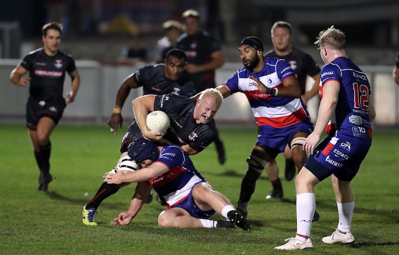  Dubai Exiles' Anthony Kapp is tackled during the match against Jebel Ali Dragons. Pawan Singh / The National   