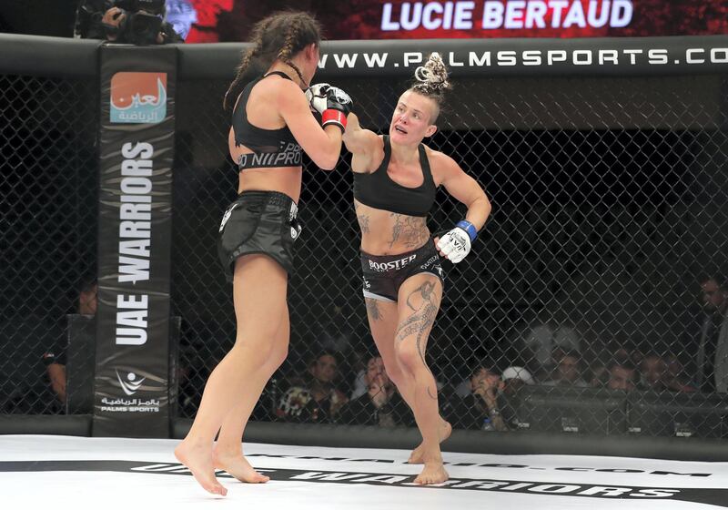 Abu Dhabi, United Arab Emirates - November 29th, 2019: Lucie Bertaud (dark hair) takes on Kelig Pinson in the flyweight division during the UAE Warriors event. Friday, November 29th, 2019, Mubadala Arena, Abu Dhabi. Chris Whiteoak / The National