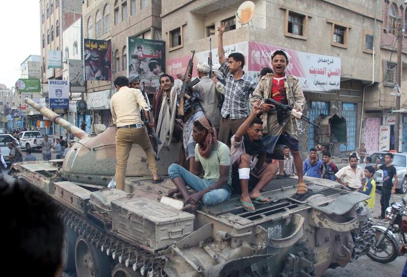 Resistance fighters loyal to the government of Yemeni president Abdrabu Mansur Hadi ride atop a tank they seized from Houthi militiamen in the city of Taez on August 17, 2015. Reuters