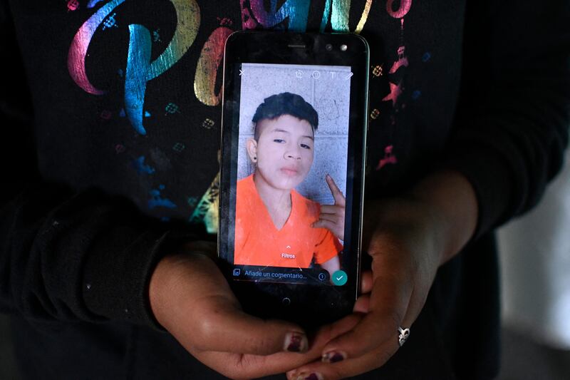 Wilmer, seen here on the mobile phone of a relative, was not the only teenager to die in the back of the lorry. Pascual Melvin Guachiac and his cousin Wilmer, both 13, also lost their lives after they suffocated in the stifling heat.  AFP