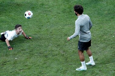 Soccer Football - UEFA Super Cup - Liverpool Training - Vodafone Park, Istanbul, Turkey - August 13, 2019 Liverpool's Mohamed Salah plays football with a child during training REUTERS/Murad Sezer TPX IMAGES OF THE DAY