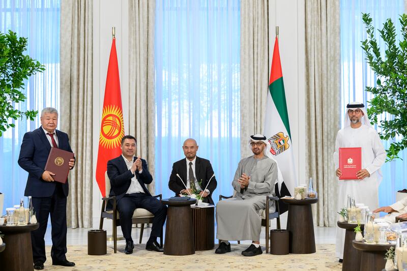 Suhail Al Mazrouei, UAE Minister of Energy and Infrastructure, and Taalaibek Ibraev, Kyrgyzstan's Minister of Energy, exchange agreements.