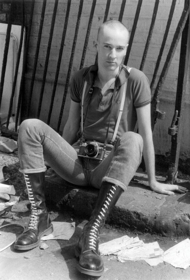 Paul Hartnett portrait. Dressed as a skinhead with Doc Martin boots and Fred Perry shirt, UK 1980's. (Photo by: Paul Hartnett/PYMCA/Universal Images Group via Getty Images)