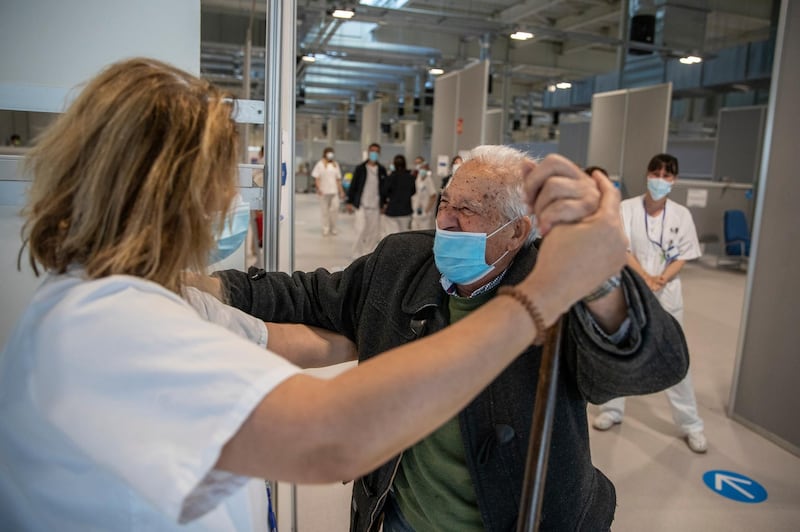 Antonio Garcia, 95, dances with a health worker before being vaccinated with the Moderna Covid-19 vaccine at the Nurse Isabel Zendal Hospital in Madrid, Spain. AP Photo
