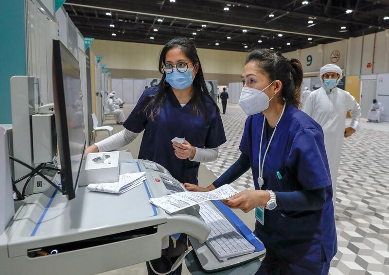 Abu Dhabi, United Arab Emirates, August 6, 2020. 
 Nurses update some records at the ADNEC volunteer facility. 
Victor Besa /The National
Section: NA
Reporter:  Shireena Al Nowais