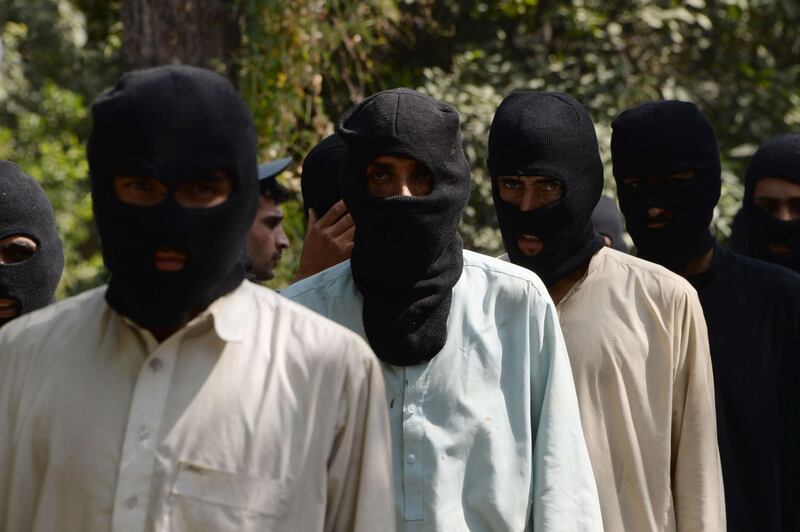 (FILES) This file photo taken on October 3, 2017 shows alleged fighters for the Islamic State and Taliban walk being presented to the media at the police headquarters in Jalalabad.
French and Algerian fighters, some arriving from Syria, have joined the ranks of the Islamic State group in northern Afghanistan where the militants have established new bases, multiple international and Afghan sources have told AFP. It is the first time that the presence of French IS fighters has been recorded in Afghanistan, and comes as analysts suggested foreigners may be heading for the war-torn country after being driven from Syria and Iraq.
 / AFP PHOTO / NOORULLAH SHIRZADA