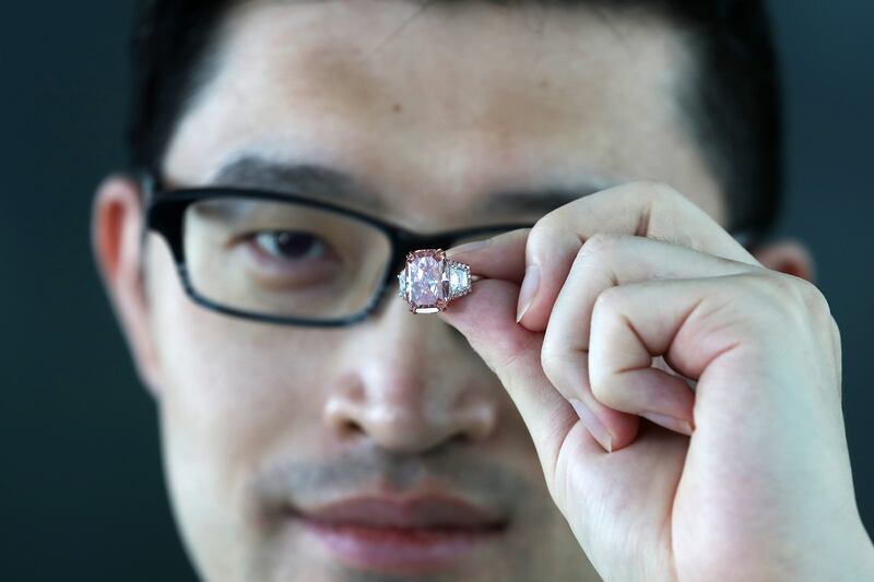 Wenhao Yu, chairman of jewellery and watches at Sotheby’s Asia shows off the stone.