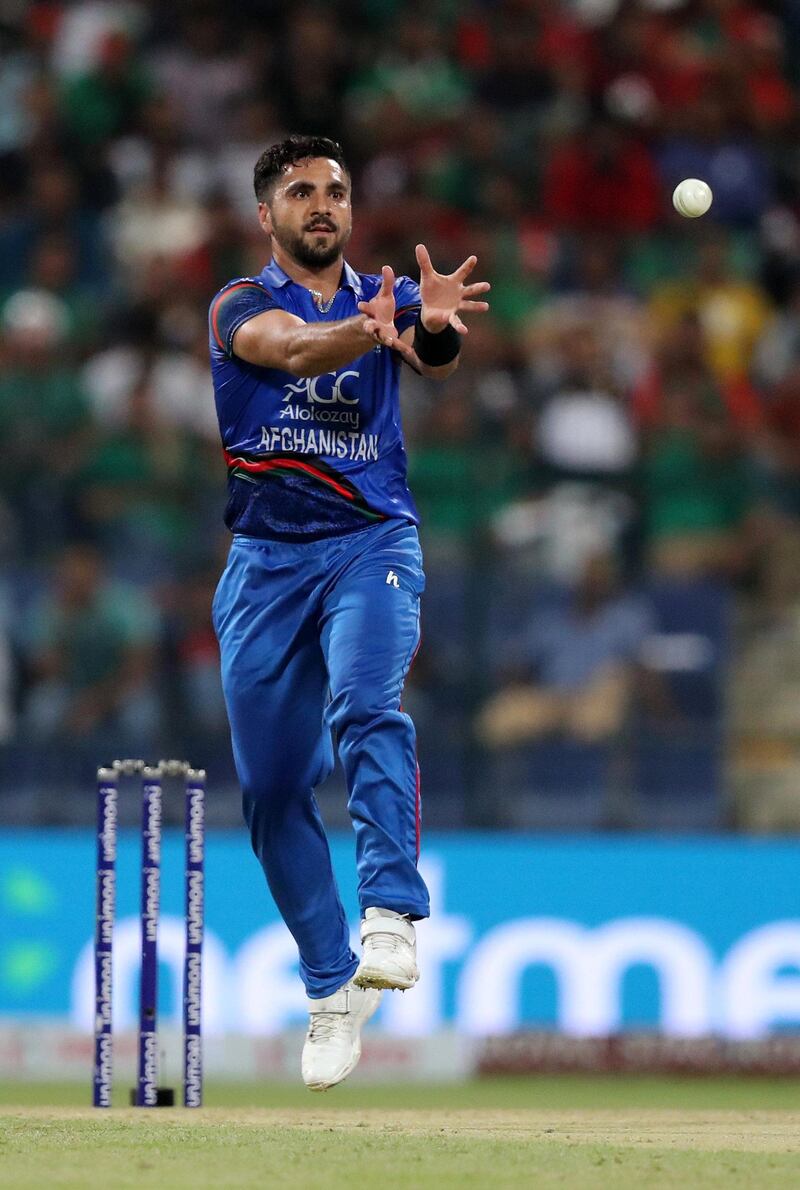 Abu Dhabi, United Arab Emirates - September 20, 2018: Afghanistan's Aftab Alam gathers the ball during the game between Bangladesh and Afghanistan in the Asia cup. Th, September 20th, 2018 at Zayed Cricket Stadium, Abu Dhabi. Chris Whiteoak / The National