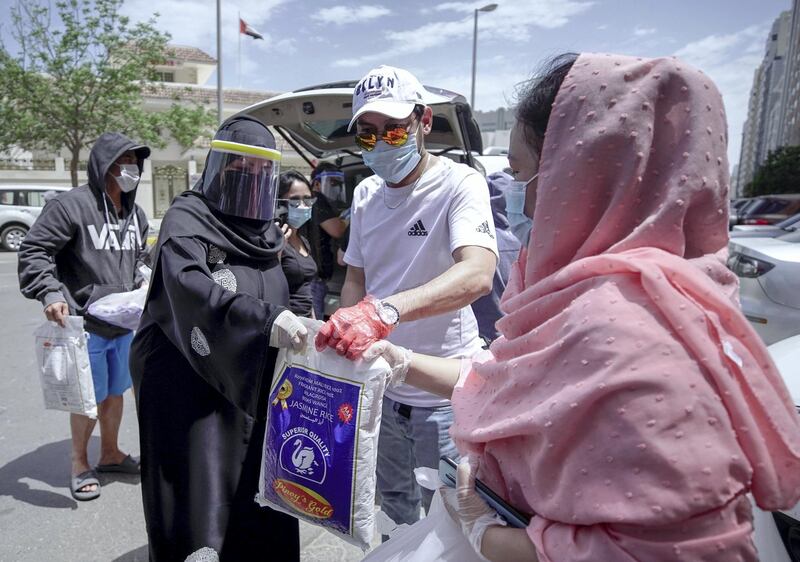Abu Dhabi, United Arab Emirates, May 1, 2020.   
 Laid off Filipino Muslim workers with their rice, eggs, cooking oil and other daily essentials given to them by Filipino-Emirati woman, Mona Mohamed Baraguir at the residential area in front of Al Wahda Mall, on a Friday morning.
Victor Besa / The National
Section:  NA
Reporter:  Shireena Al Nuwais