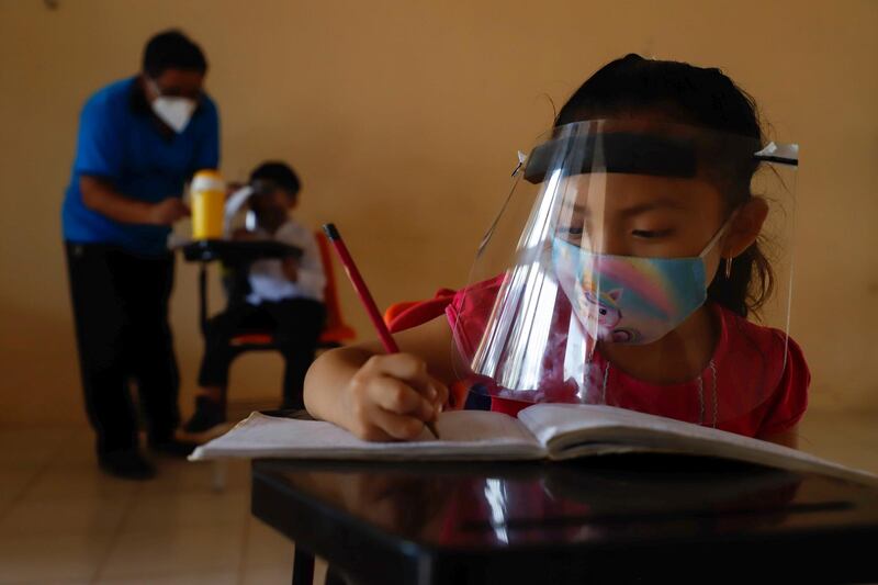 Ten-year-old Jade Chan Puc writes in her notebook during the first day of class at the Valentín Gomez Farias Indigenous Primary School in Montebello, Hecelchakan, Campeche state, Mexico. AP Photo