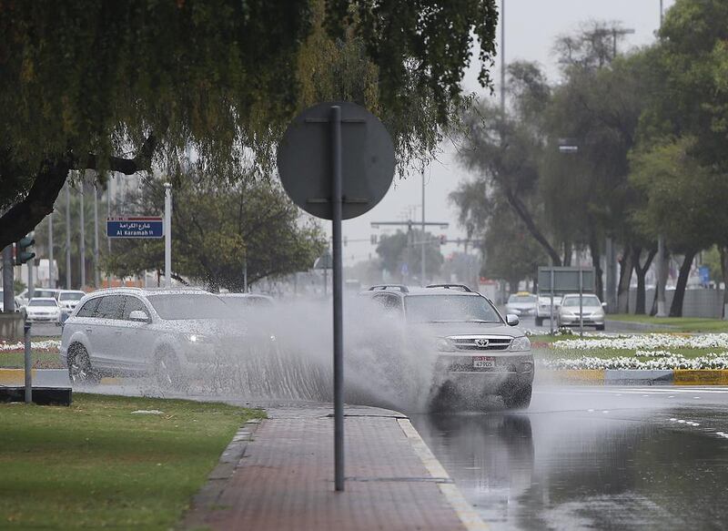 Motorists drive through a flooded street in Abu Dhabi. Ravindranath K / The National