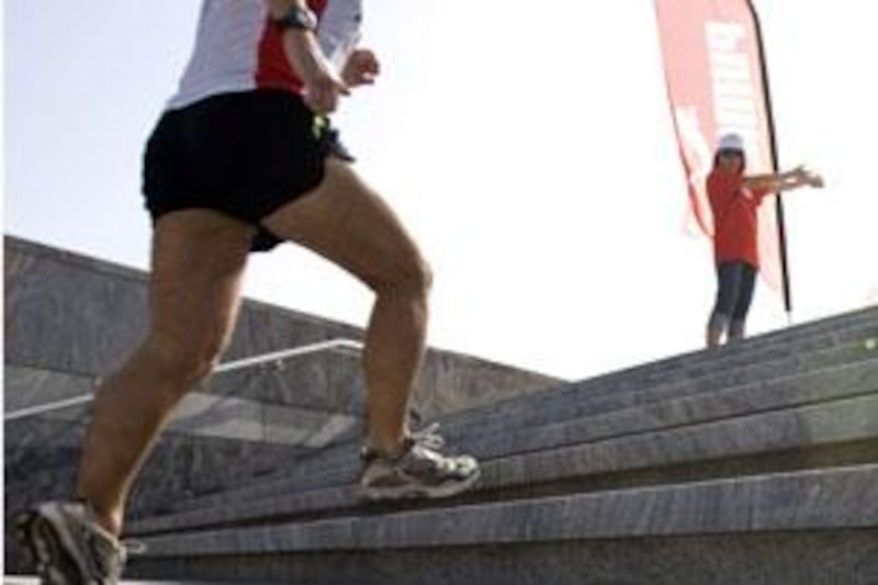 A participant in the Vertical Marathon begins the climb up the stairs of Emirates Towers in Dubai on May 29, 2009.