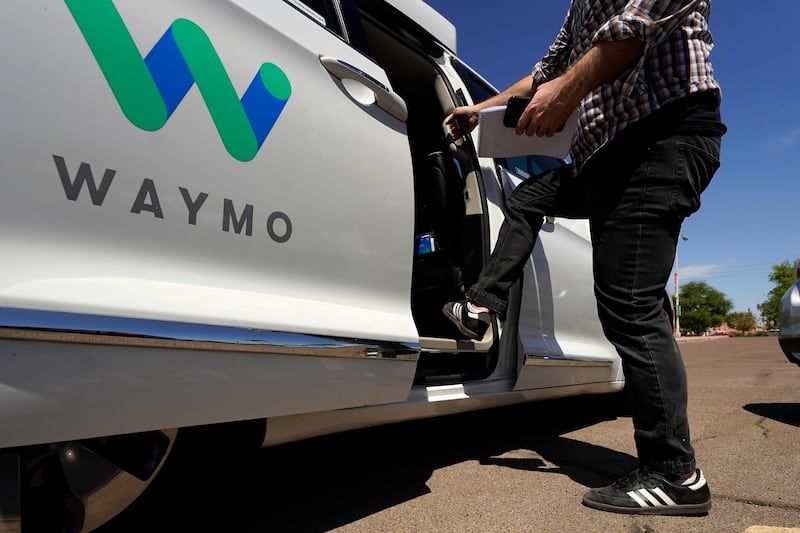 A Waymo minivan arrives to pick up passengers for an autonomous vehicle ride in Mesa, Arizona. AP