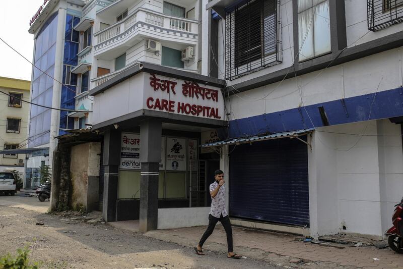 A pedestrian walks past a private hospital in Boisar in Maharashtra, the worst-affected state in India's coronavirus outbreak. Bloomberg