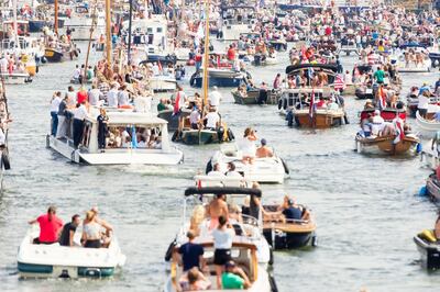 Color image of a very large group of boats and people sailing on Ij river in Amsterdam, the Netherlands. Selective focus on the background. Getty Images