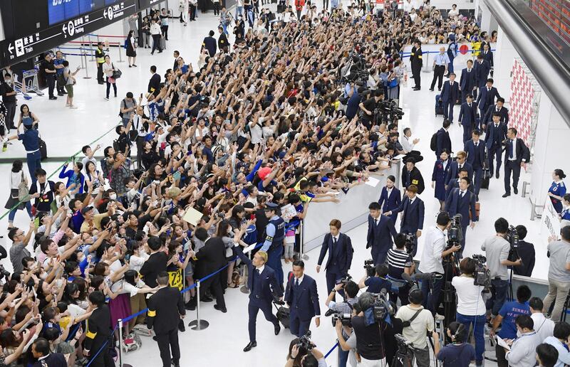 Members of the Japanese national football team are greeted by fans as they return to Narita international airport after being defeated by Belgium in the World Cup round of 16 match in Russia, in Narita, east of Tokyo, Japan. Reuters