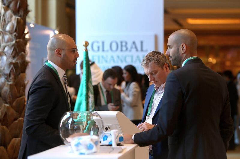 Visitors take a look at the booths of exhibitors at the Global Financial Markets Forum in Abu Dhabi. Ravindranath K / The National