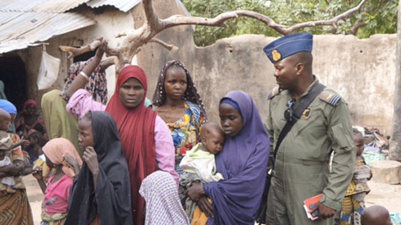 A soldier from the Nigerian Army talks with hostage women and children who were freed from Boko Haram, in Yola, in this April 29, 2015 handout. Nigeria's military rescued another set of women and children who had been kidnapped by Boko Haram militia and were being detained in Sambisa forest where the Islamist group has been holed up, an army spokesman said on April 30. Picture taken April 29, 2015. REUTERS/Nigerian Military/Handout via Reuters    
ATTENTION EDITORS - THIS PICTURE WAS PROVIDED BY A THIRD PARTY. REUTERS IS UNABLE TO INDEPENDENTLY VERIFY THE AUTHENTICITY, CONTENT, LOCATION OR DATE OF THIS IMAGE. THIS PICTURE IS DISTRIBUTED EXACTLY AS RECEIVED BY REUTERS, AS A SERVICE TO CLIENTS. 
FOR EDITORIAL USE ONLY. NOT FOR SALE FOR MARKETING OR ADVERTISING CAMPAIGNS.