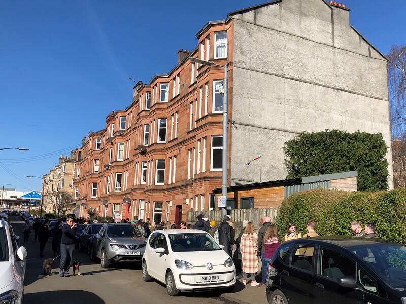 People queue around the block to buy cakes, buns and other baked treats from the Deanston Bakery in Glasgow. The sale has raised at least £25,000 for Ukraine's refugees.