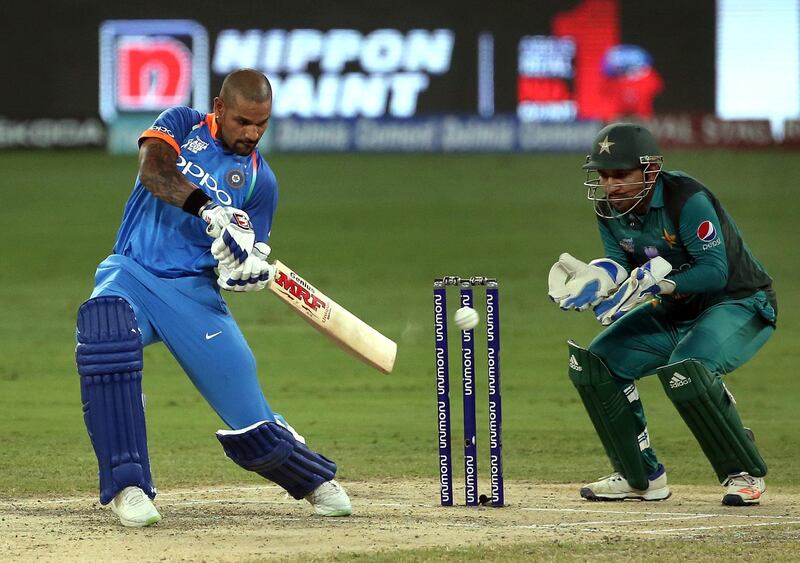 India's Shikhar Dhawan, left, bats during the one day international cricket match of Asia Cup between India and Pakistan in Dubai, United Arab Emirates, Sunday, Sept. 23, 2018. (AP Photo/Aijaz Rahi)