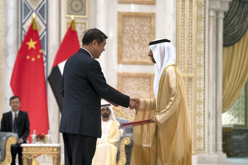 ABU DHABI, UNITED ARAB EMIRATES - July 20, 2018:  HE Suhail bin Mohamed Faraj Faris Al Mazrouei, UAE Minister of Energy (R), exchanges an MOU with a member of the Chinese delegation, during a reception for HE Xi Jinping, President of China (not shown), at the Presidential Palace. 

( Mohamed Al Hammadi / Crown Prince Court - Abu Dhabi )
---