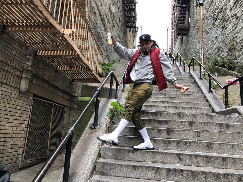 Jay Garcia, a radio host from Queens, dances down the 'Joker' steps in the Bronx borough of New York, US, on Wednesday, October 16, 2019. Reuters