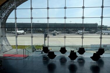 An empty waiting room and aircraft on the tarmac at Terminal 2E at Charles de Gaulle airport in Roissy-en-France, north of Paris. Global air passenger traffic plunged by an unprecedented 66 percent in 2020 due to travel restrictions imposed over the Covid-19 pandemic, Iata said. AFP