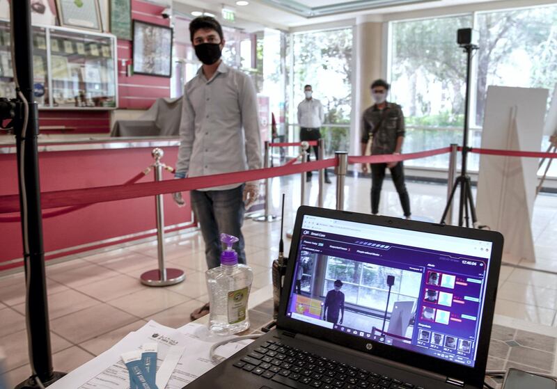 Abu Dhabi, United Arab Emirates, May 18, 2020.    
Mall workers must pass thermal scanners and present proper identification before entering the Al Raha Mall on the first day of reopening during the Covid-19 pandemic.
Victor Besa / The National
Section:  NA
Reporter: