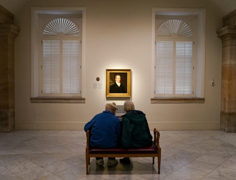 A couple looks at a portrait of President James Monroe at the National Portrait Gallery in Washington. Reuters