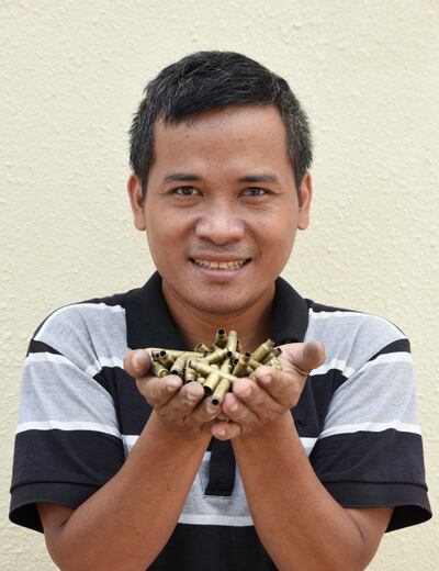 Chantha Thoeun with the bullets and shell casings that he uses to create his jewellery. Courtesy Ronan O'Connell