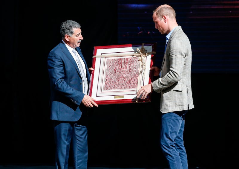 Britain's Prince William receives a gift from Musa Hadid, the mayor of Ramallah, at a reception during his visit to the West Bank city's municipality. The Duke of Cambridge is the first member of the royal family to make an official visit to the Jewish state and the Palestinian territories. Abbas Momani / AFP