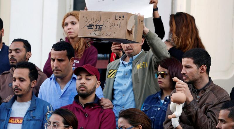 People take part in a protest after 11 babies mysteriously died in a hospital in Tunis, Tunisia. The wording on the box reads: 'A gift for the Minister of Health''. Reuters