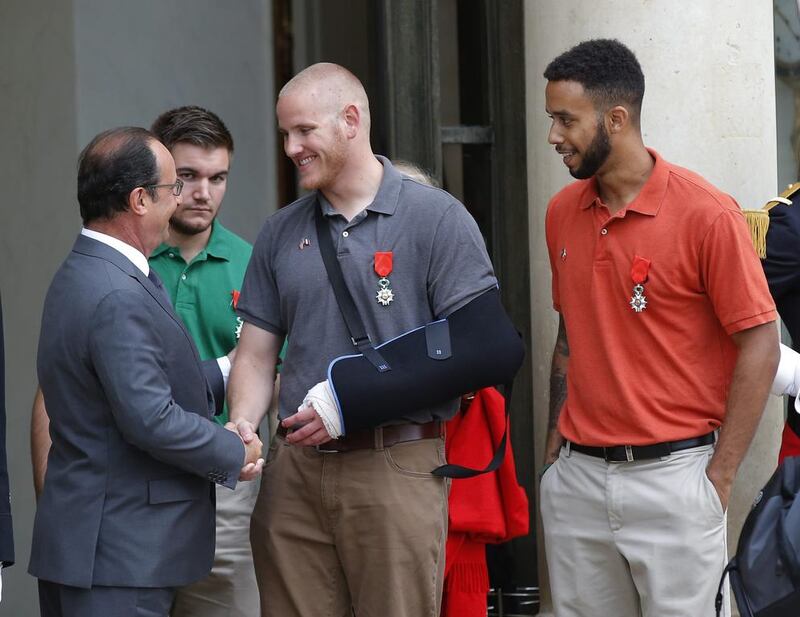 French president Francois Hollande bids farewell to US Airman Spencer Stone as American National Guardsman Alek Skarlatos of Roseburg, second from left, and Anthony Sadler, a senior at Sacramento State University in California, look on, at the Elysee Palace in Paris, France. The three American travelers say they relied on gut instinct and a close bond forged over years of friendship as they took down a heavily armed man on a passenger train. Michel Euler / AP Photo