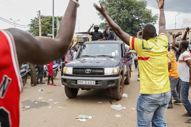 Crowds cheer as soldiers parade in vehicles along the Boulevard de l'Independance in Bamako, Mali. Getty Images