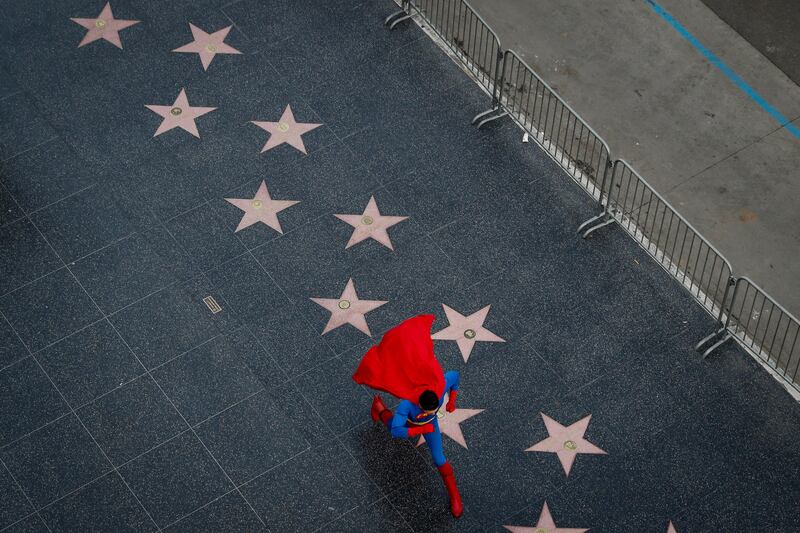 Wearing a Superman costume, Toly Shtapenko, of Ukraine, takes a long stride along the Hollywood Walk of Fame to impress tourists, in the Hollywood section of Los Angeles. While the Hollywood we see in movies is a place of glamour and beautiful celebrities, the cast of superheroes filling Hollywood Boulevard is frequently anything but. Many are people struggling to make a buck as they pursue their dream of stardom. Jae C. Hong / AP Photo