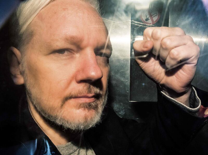 (FILES) In this file photo taken on May 01, 2019 WikiLeaks founder Julian Assange gestures from the window of a prison van as he is driven out of Southwark Crown Court in London, after having been sentenced to 50 weeks in prison for breaching his bail conditions in 2012. Julian Assange has been subjected to drawn-out "psychological torture", a UN rights expert said May 31, 2019, accusing the United States, Britain, Ecuador and Sweden of "collective persecution" of the WikiLeaks founder. The United Nations special rapporteur on torture and other cruel, inhuman or degrading treatment, Nils Melzer, also warned that if London agrees to an extradition request from Washington, Assange risked the death penalty.
 / AFP / Daniel LEAL-OLIVAS
