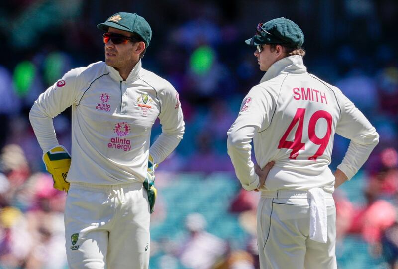 Australian captain Tim Paine, left, talks with teammate Steve Smith during play on day three of the third cricket test between India and Australia at the Sydney Cricket Ground, Sydney, Australia, Saturday, Jan. 9, 2021. (AP Photo/Rick Rycroft)