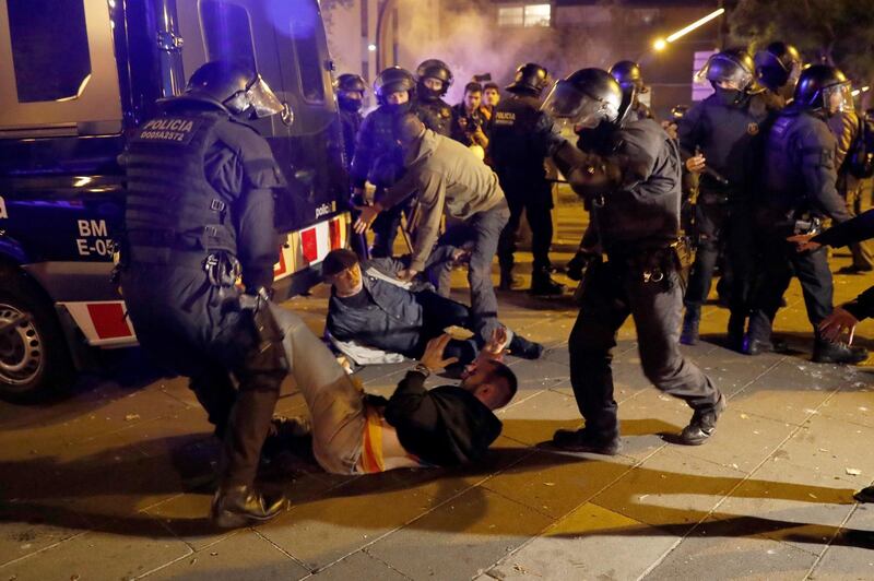 Police arrest a protester in the surroundings of Camp Nou stadium. EPA