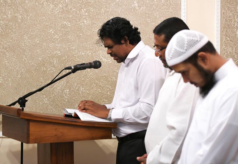 Abu Dhabi, United Arab Emirates - Mr. Asitha Fernando for the Catholic religion prays for the people who lost their lives at the heinous terrorist attacks, which took place on Easter in Sri Lanka at the Sri Lankan Embassy in Abu Dhabi. Khushnum Bhandari for The National