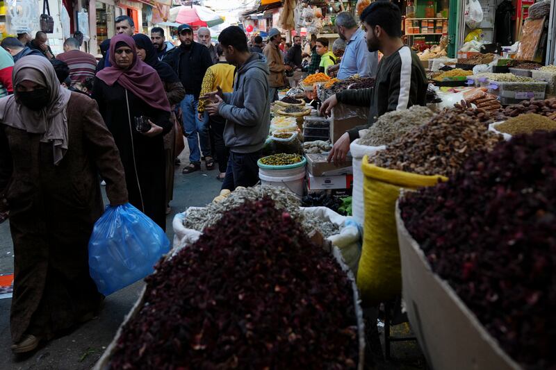While some Gazans wear face masks as they go about their shopping, the authorities have not announced coronavirus restrictions this Ramadan. AP Photo