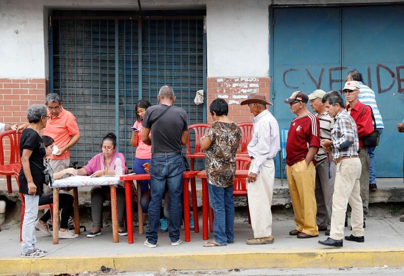 Venezuelan citizens check in at a 'Red Point,' an area set up by President Nicolas Maduro's party, to verify that they cast their votes during the presidential election in Barquisimeto, Venezuela. Carlos Jasso / Reuters