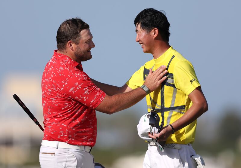 Zander Lombard shakes hands with Rikuya Hoshino on the 18th green. Getty