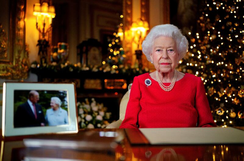 Britain's Queen Elizabeth records her annual Christmas broadcast in Windsor Castle, next to a photograph of her with her late husband, the Duke of Edinburgh. Reuters