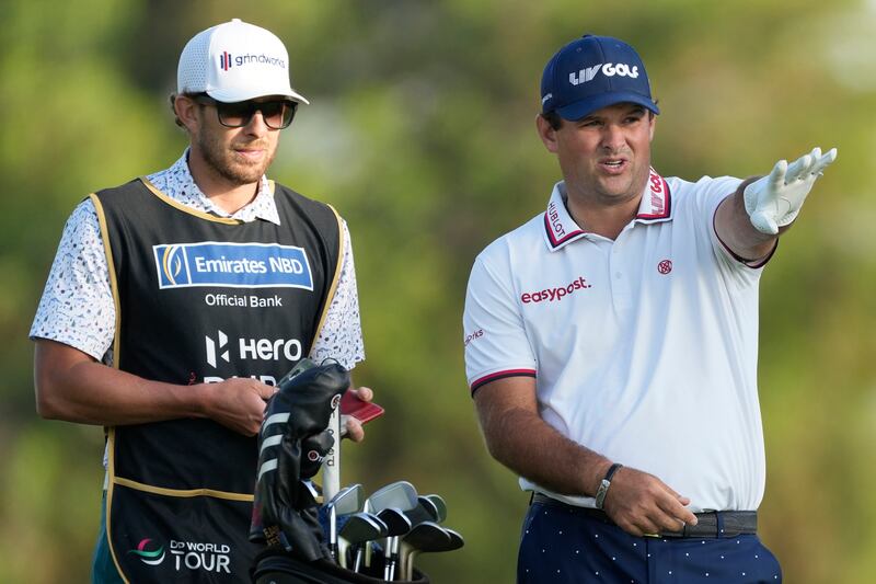 Patrick Reed talks to his caddie on the 18th hole on his way to a third-round 69 that left the American four shots off the lead. AP