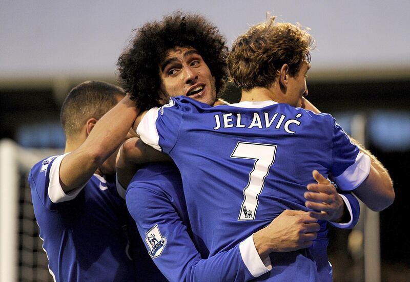 Everton's Marouane Fellaini, center, celebrates scoring against Fulham with teammate Nikica Jelavic during the English Premier League soccer match at Craven Cottage, London, Saturday Nov. 3, 2012. The match ended in a 2-2 draw. (AP Photo/PA, Jonathan Brady) UNITED KINGDOM OUT  NO SALES  NO ARCHIVE *** Local Caption ***  Britain Soccer Premier League.JPEG-04046.jpg