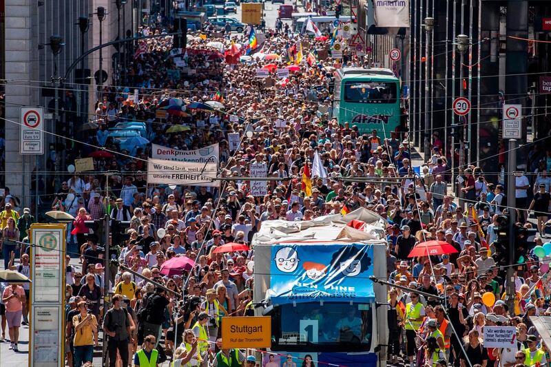 Thousands of demonstrators march down the Friedrichstrasse street as they take part in a demonstration by the initiative 'Querdenken-711' with the slogan 'the end of the pandemic-the day of freedom' to protest against the current measures to curb the spread of the Coronavirus, in Berlin.  AFP