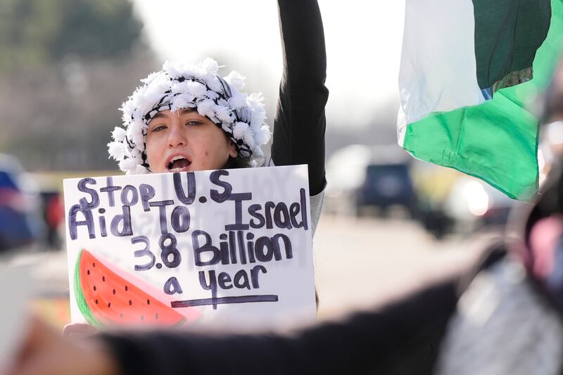 Protesters gather outside The Henry hotel hoping to be heard by members of the White House delegation who met Muslim and Arab-American leaders in Dearborn, Michigan. AP